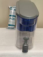 Dispenser front view with spigot and sealed filter