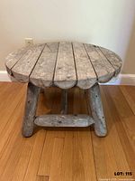 Front view of round cedar log table showing top and legs