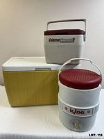 Three coolers stacked: large yellow chest cooler, Coleman Personal 8 cooler, Igloo drink cooler