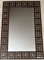 Front view showing mirror glass and decorative metal border