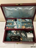 Open jewelry box showing interior tray with assorted jewelry