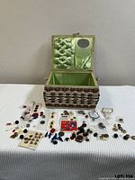 Open sewing box with satin lining and full array of buttons displayed