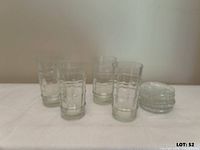 Group of four tumblers and stack of six cut-glass coasters