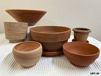 Group shot of all six pots and two saucers