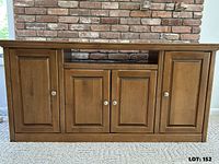 Front view of hardwood TV stand with doors closed