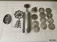Full set laid out: press, rosette molds, discs