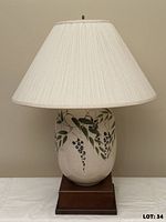 Lamp front view showing painted wisteria design, shade, wooden base