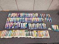 Full lot view showing all 117 paint tubes laid out by color groups