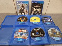 All eight PS4 discs and two cases laid out