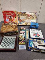 Group shot showing all boxed board games, card games, chessboard, card shuffler