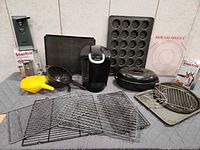 Full group shot showing coffee maker, can opener, bakeware and accessories