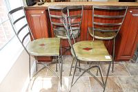 Group of four matching bar stools set in front of kitchen island