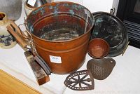 Copper ash bucket showing patina, with accompanying copper bowl, round pan and kitchen tools