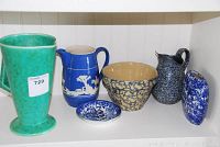 Overview of six pottery pieces including various pitchers, bowls and dishes on shelf