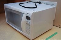 White Panasonic microwave model NN-SA636W showing full front and top view with power cord on top.