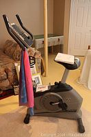 Left-front view of bike showing frame, pedals, seat and stretch bands