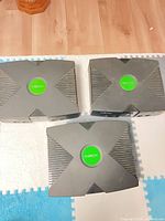 Top view of three original Xbox consoles