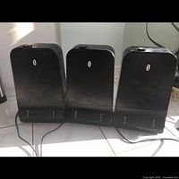 Front view of three identical black Sonic humidifiers with cords