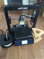 Front view of Anycubic i3 Mega printer with spool holder and filament