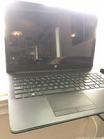 Open HP laptop showing screen, keyboard and chassis