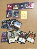 Overview of entire lot showing Star Trek, Dragon Ball Z and Magic cards spread on table