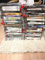 Three tall stacks showing majority of the 41 PS3 game cases