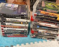 Two stacks of PS3 cases showing spines