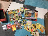 Lot overview showing stacks of cards, promo cards, poster collection box and token