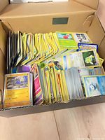 Shoebox filled with stacked Pokémon cards