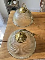 Two ribbed glass dome pendant lamps showing full form, chains, wiring