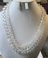 Entire necklace displayed doubled on bust showing clear faceted beads