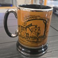 Full view showing horse and groom scene on side, handle, tan body and black base