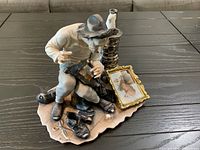 Front view of multicolor porcelain cobbler figurine with accessories