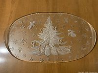 Top view of clear frosted glass oval platter with Christmas tree and snowflake design