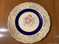 Front view showing cobalt rim, floral center, gold filigree