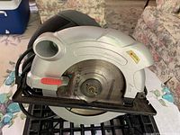 Side view of Laser corded circular saw showing blade, base plate, handle and power cord