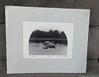 Front view of matted black and white print in shrink wrap