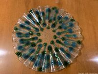 Top view of clear glass plate with blue/teal and green pattern