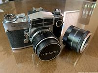 Front angled view of Miranda Sensorex body with mounted 50mm f/1.8 lens, teleconverter beside