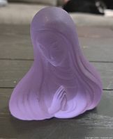 Front view of purple frosted glass praying figurine