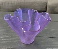 Ruffled amethyst glass vase showing overall shape and color