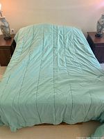 Comforter spread on bed showing full size and quilted lines
