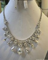Front view showing full bib necklace with teardrop crystal drops