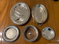 All five silver-plated serving pieces displayed