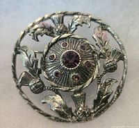 Front view showing floral motif and purple rhinestones