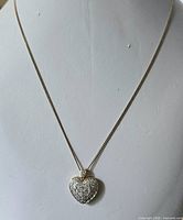 Full view of necklace displayed on bust showing chain length and heart pendant