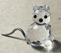 Front view of clear faceted crystal mouse with metal tail, black eyes and nose