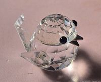 Side view of faceted Swarovski crystal chick showing tail, wing, and eye details