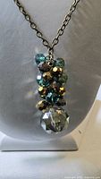 Close view of bead cluster pendant showing colors and faceting