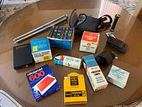 Lot overview showing all boxed film, lamps, lens, finder, tripod and stabilizer